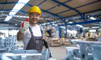 portrait-factory-worker-protective-equipment-holding-thumbs-up-production-hall